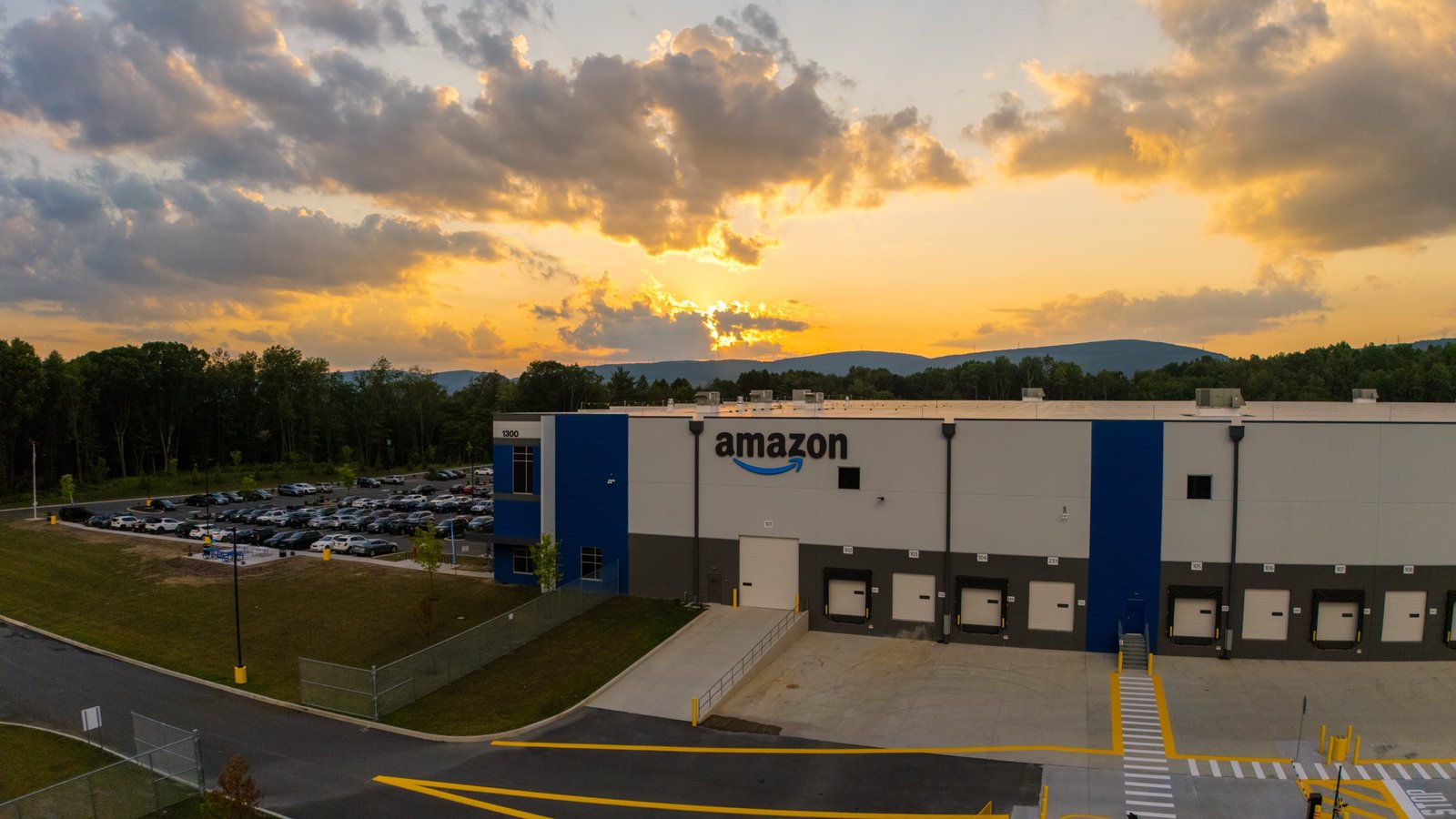 Amazon distribution center photographed from above at sunset