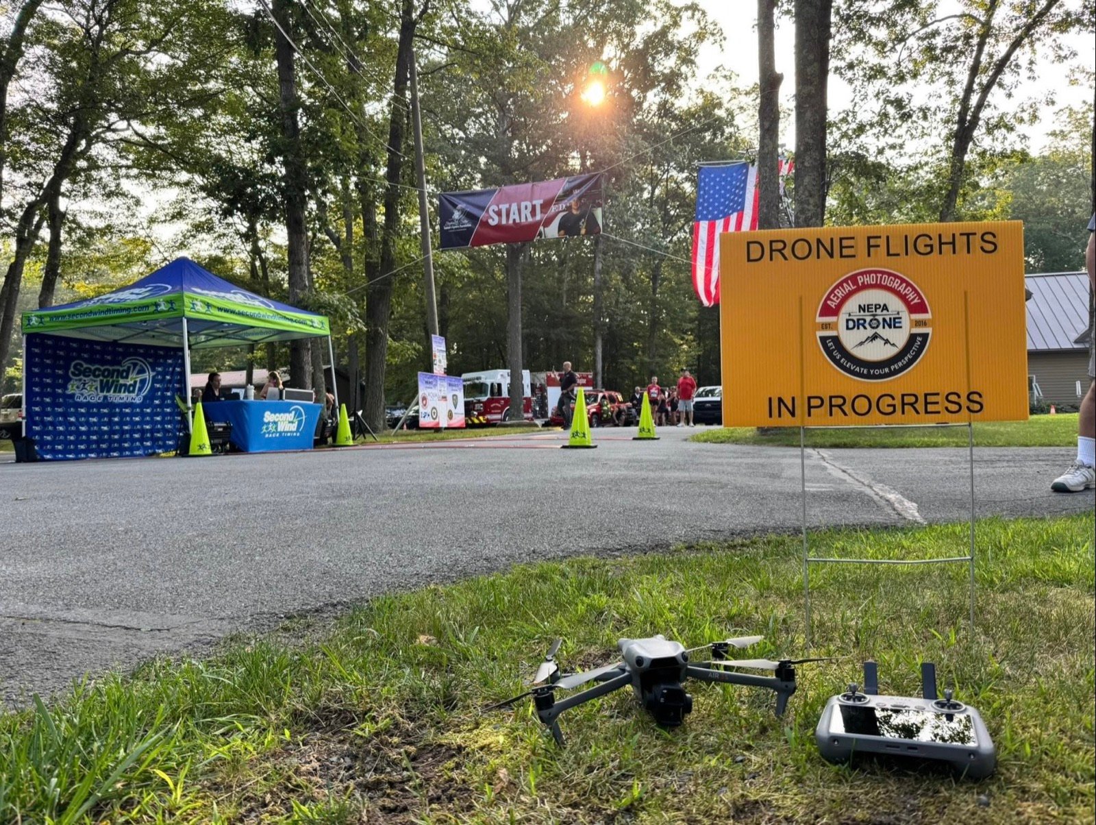NEPA Drone set up beside a Drone Flights in Progress sign at an outdoor event