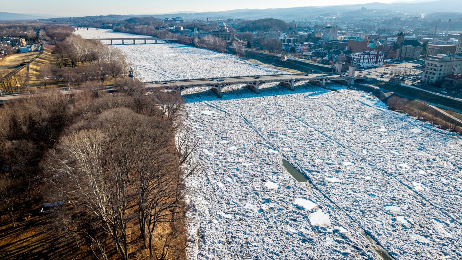 River choked with ice beneath a bridge